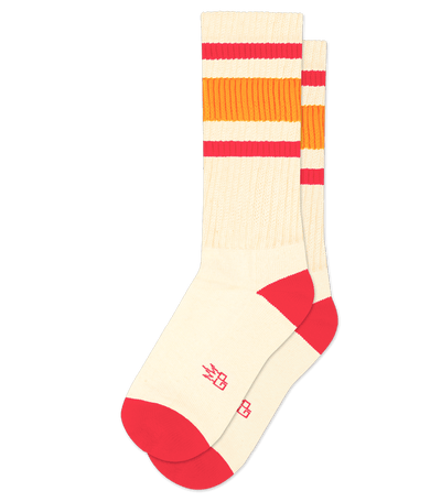 Pair of natural cotton socks with fuschia accents and striped pattern.