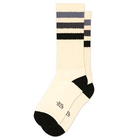 Cotton socks in natural with black accents, logo on foot, striped pattern on upper.
