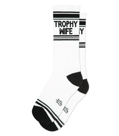 White socks with "Trophy Wife" text on the cuff, featuring black accents on the toes and heels.