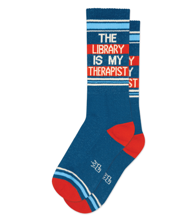 Dark blue sock with text "THE LIBRARY IS MY THERAPIST" and light blue stripes.