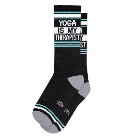 Black socks with light teal accents and text "YOGA IS MY THERAPIST" on transparent background.