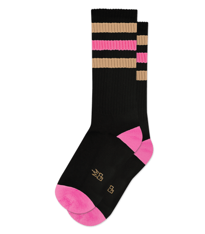 Black socks with light brown stripes and pink heels and toes, displaying small gold symbols on foot.