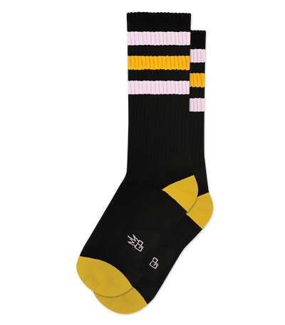 Black sock with gold accents, featuring bold horizontal stripes in white and gold near the top.