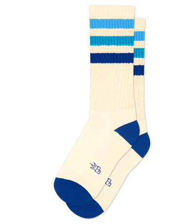 Pair of natural cotton socks with royal blue accents and stripes, no visible text.