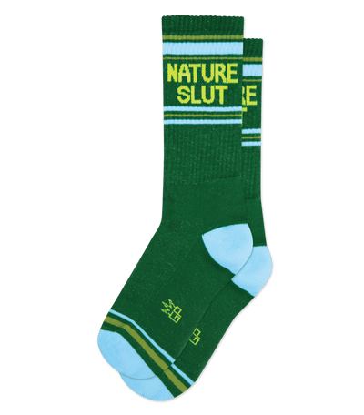 Dark green socks with camo green accents and text "NATURE SLUT" in yellow above white stripe.